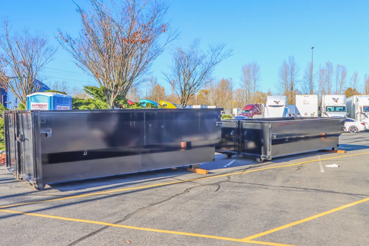 Professional dumpster rental service with roll-off container on residential driveway in Fortuna